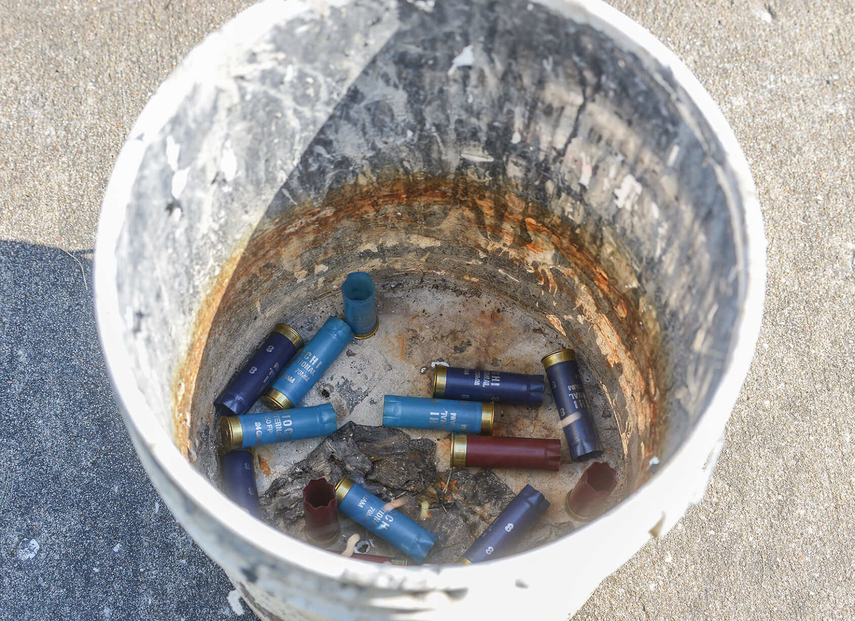 Shotgun shells lay in a bucket